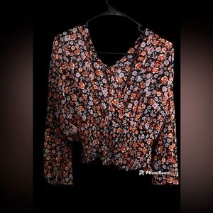 Thin low cut floral top with bright colored flowers on it.